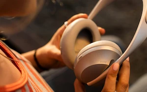 Woman staring at brownish headphones in hands